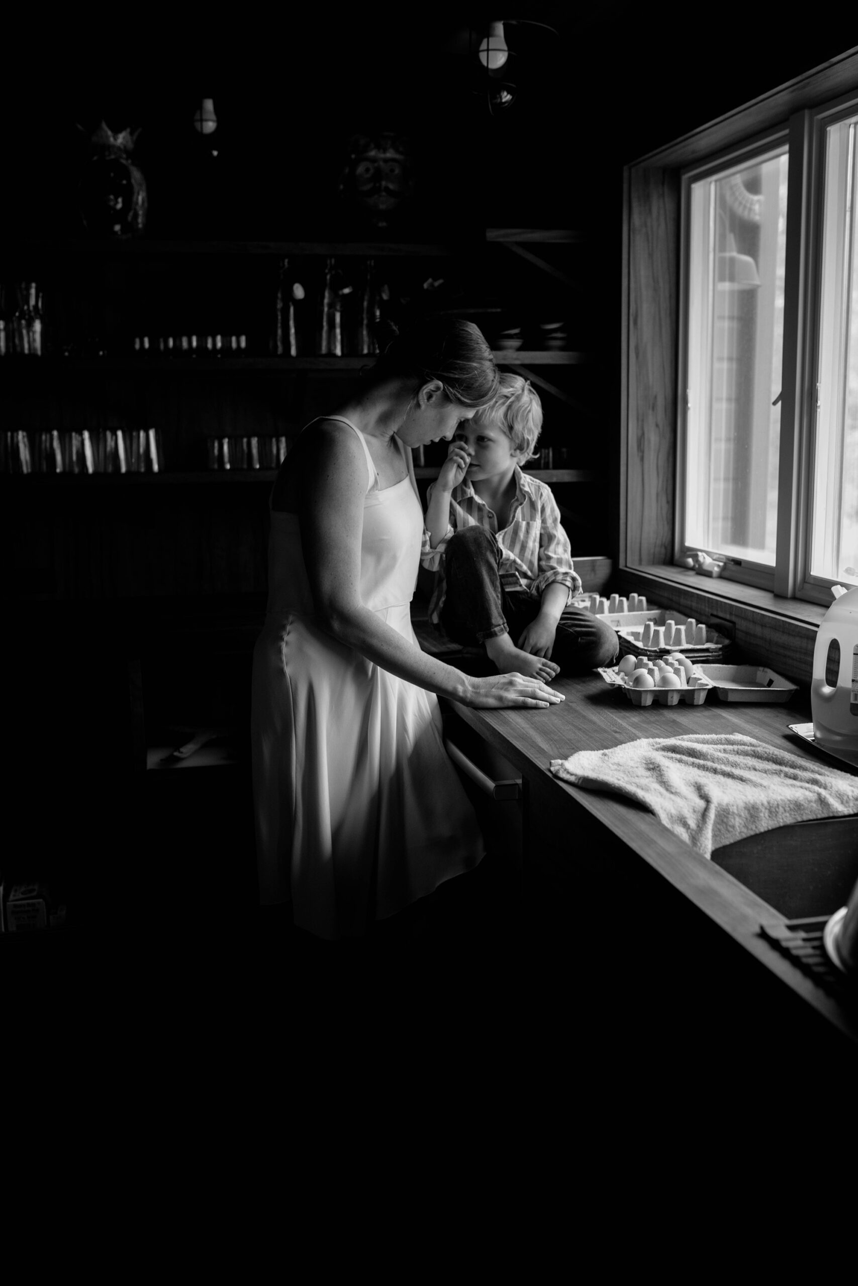 a loving moment between mom and son in a farmhouse kitchen. farm family photoshoot at home 