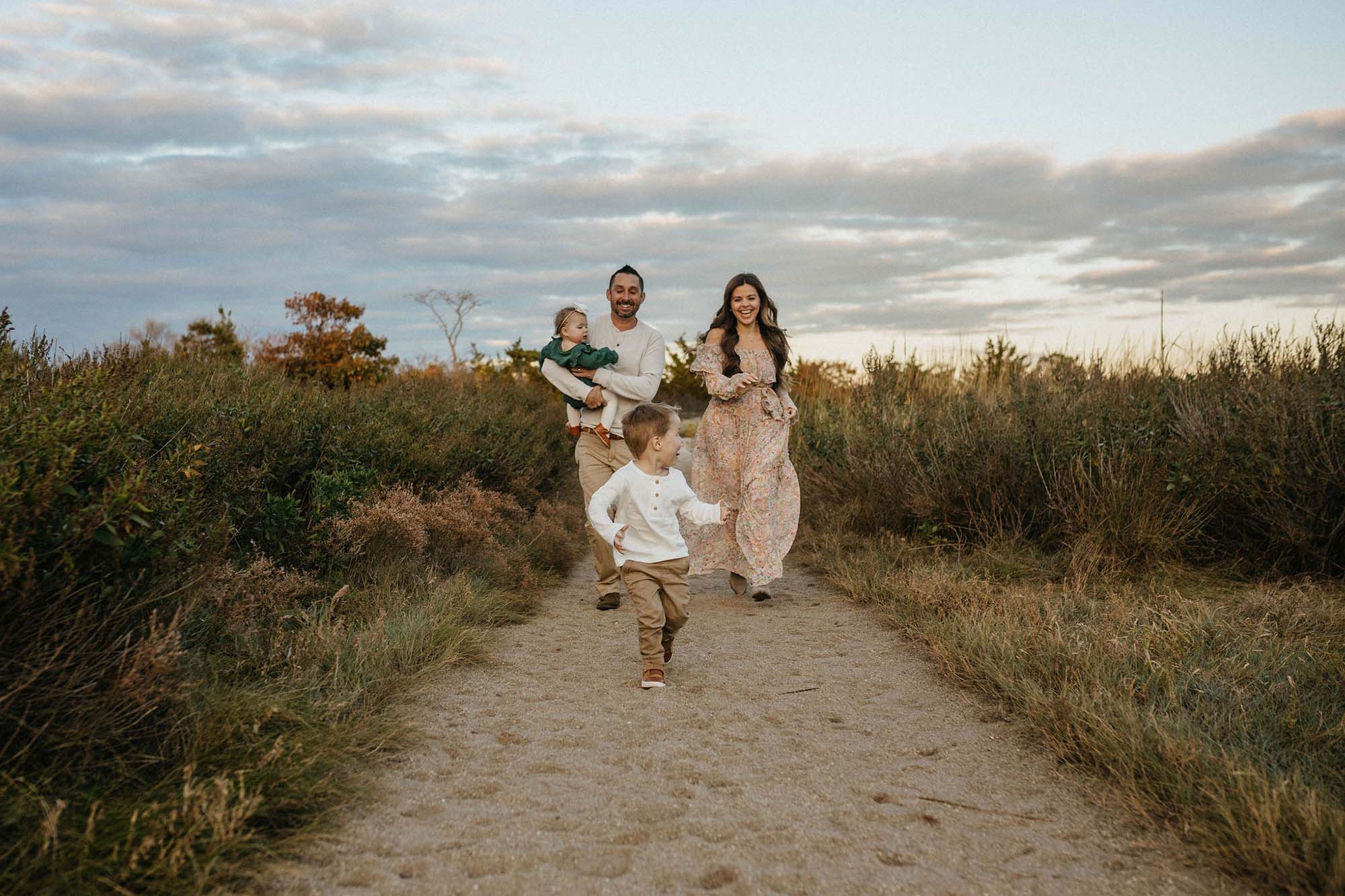 family of four running on the beach,  beach family portraits, Long Island family photographer