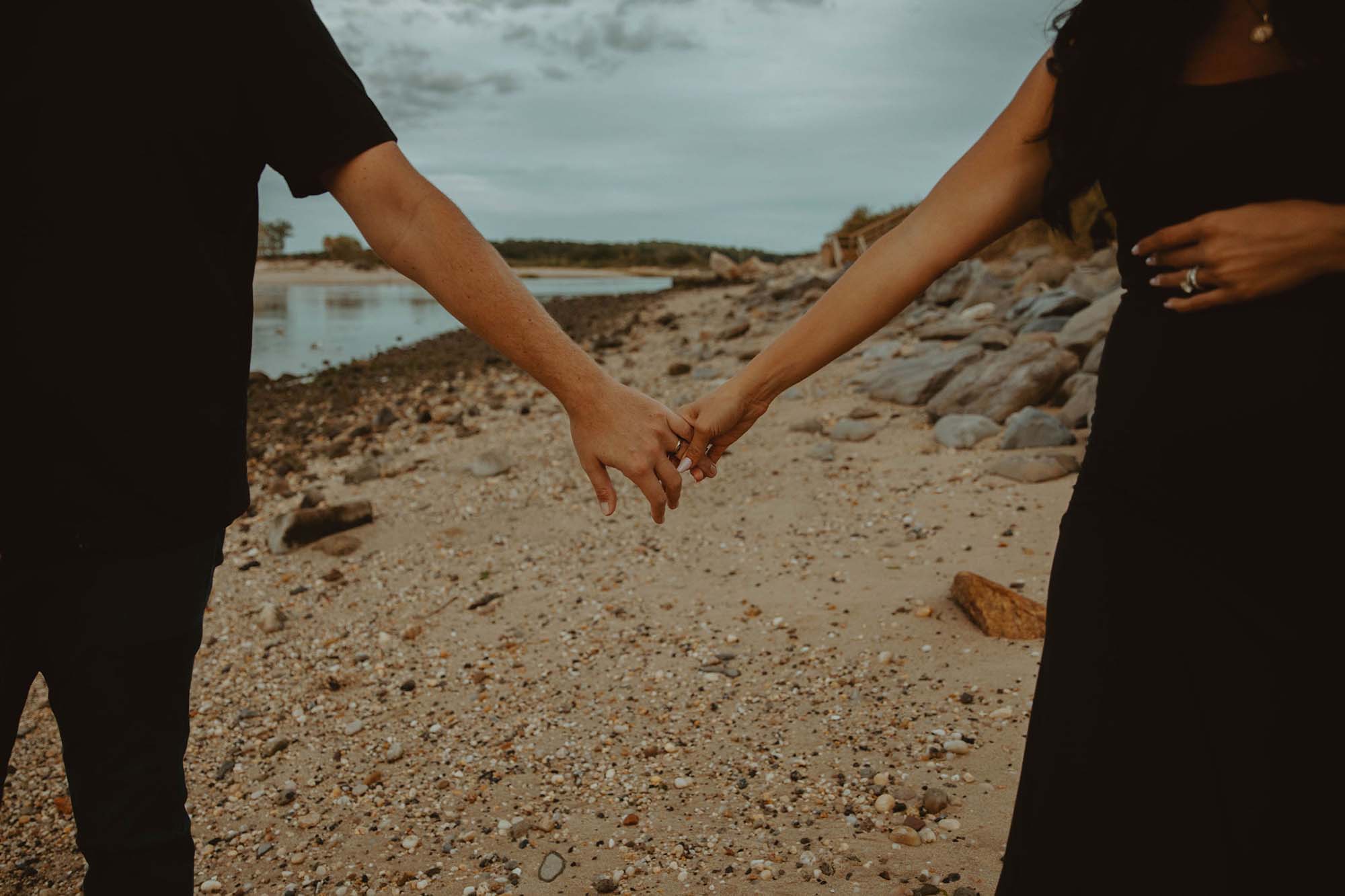 couple portrait holding hands on the beach