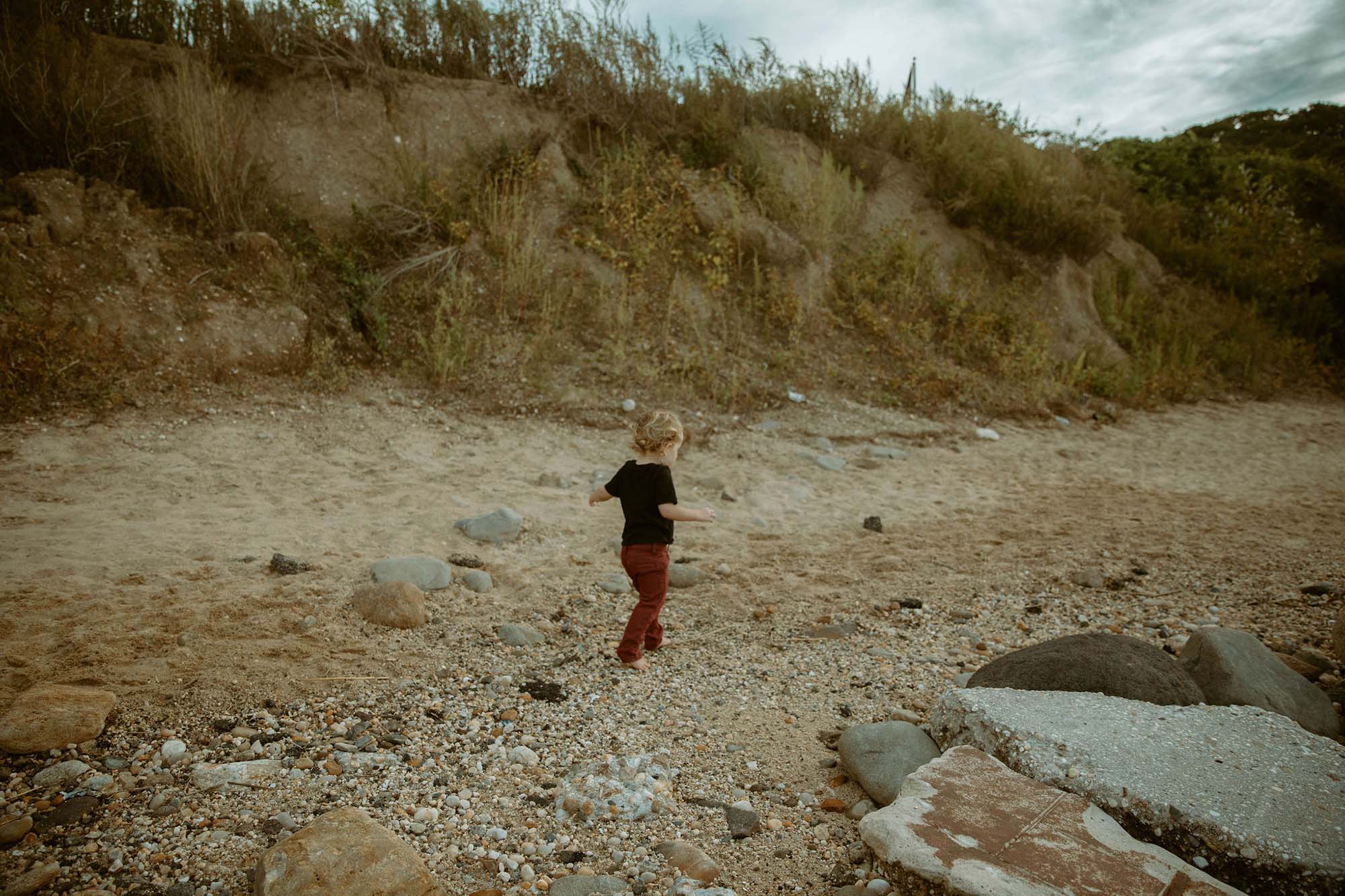 child walking in the sand on the beach, Long Island family photographer 